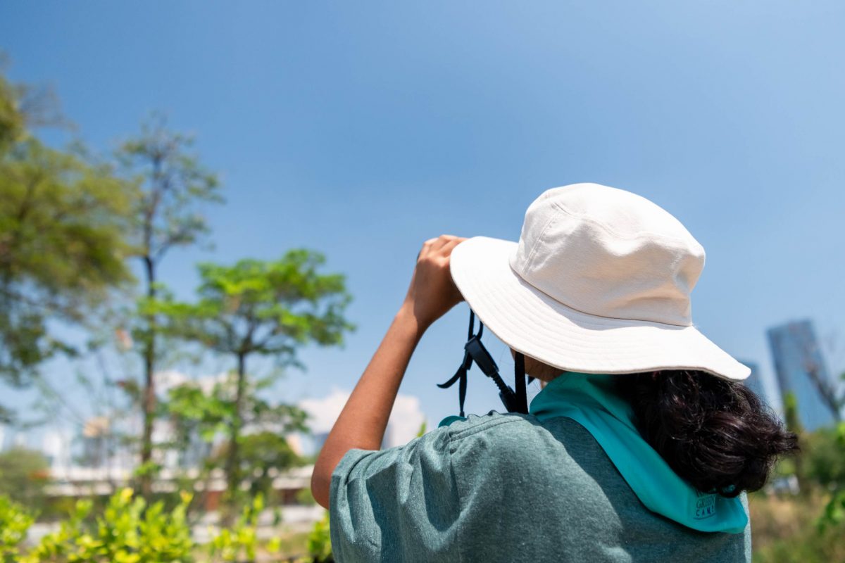 a girl who is wearing a hat, bird watching